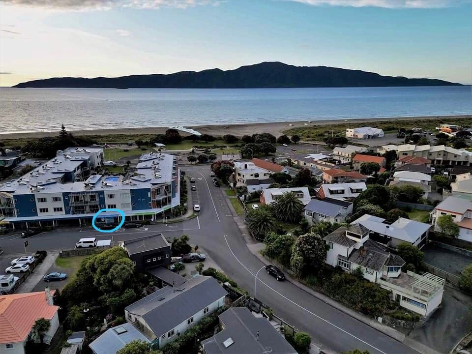 Aerial view of Paraparaumu Beach with the CoreGood clinic ringed, on Seaview Road facing Kāpiti Island